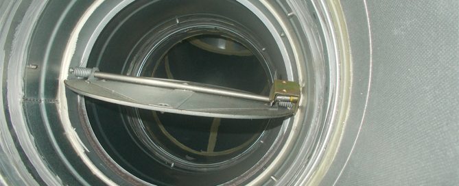 Open circular fire damper showing internal mechanism