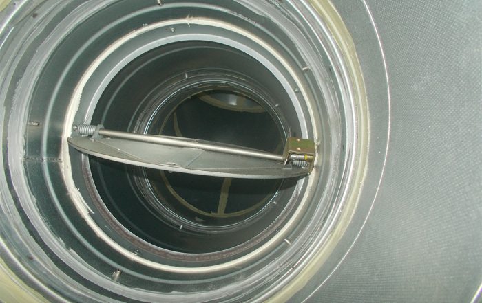 Open circular fire damper showing internal mechanism